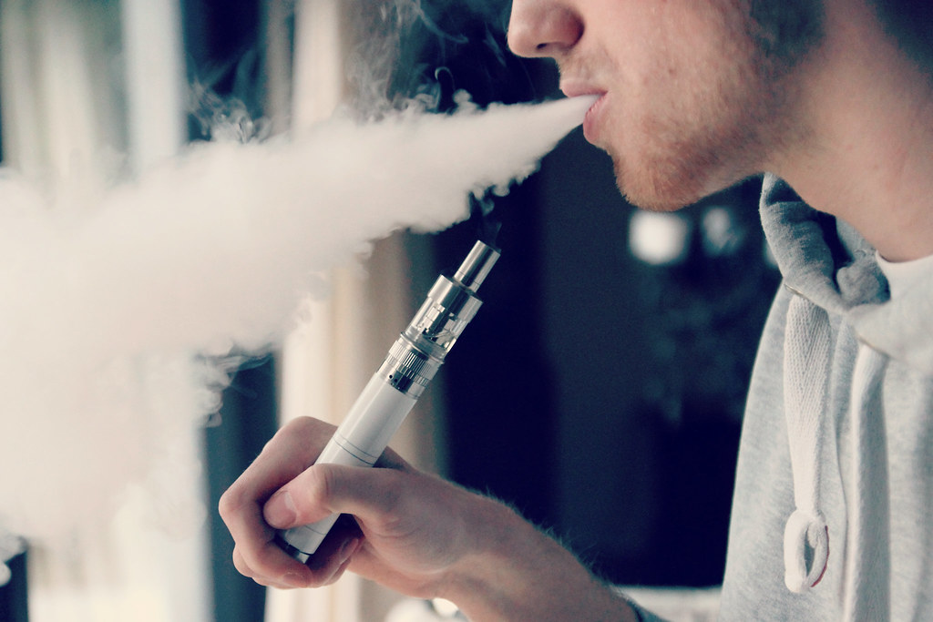 Man exhaling vapor from an e-cigarette